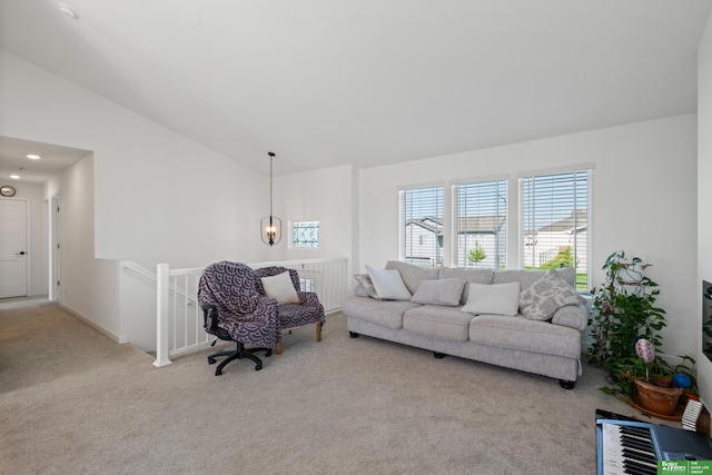 carpeted living room with vaulted ceiling and baseboards