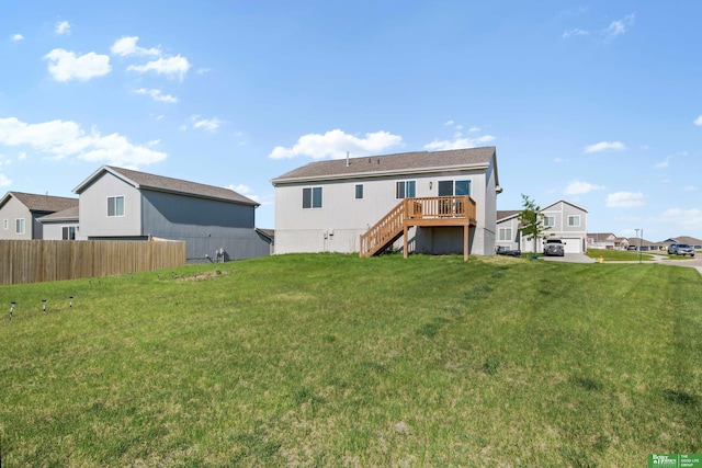 back of property with stairs, a deck, and a residential view