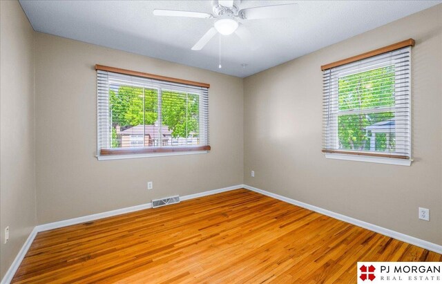 13577 Shirley St, Omaha, NE 68144 - empty room featuring wood finished floors, baseboards, and a ceiling fan