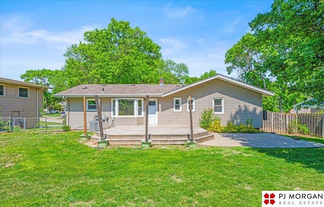 13577 Shirley St, Omaha, NE 68144 - back of house with a patio, a chimney, and a wooden deck