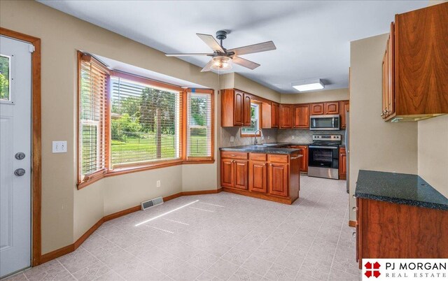 13577 Shirley St, Omaha, NE 68144 - kitchen featuring stainless steel appliances, brown cabinetry, plenty of natural light, and a ceiling fan