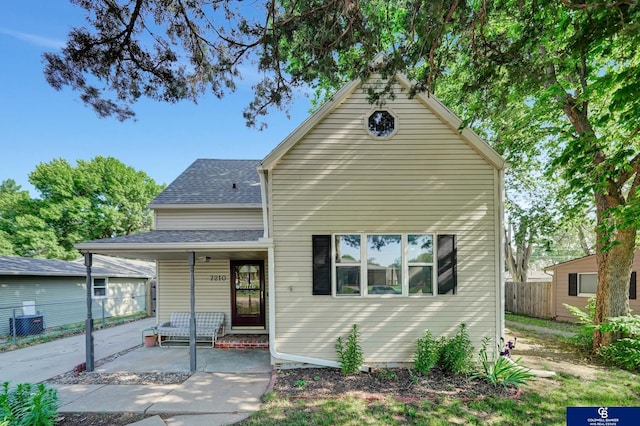 7210 Stanton St, Lincoln, NE 68507 - view of front facade featuring fence, covered porch, and roof with shingles
