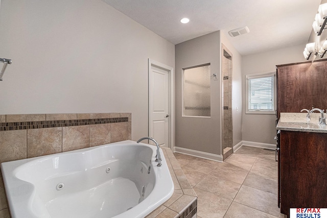 948 S 198th St, Omaha, NE 68022 - full bath with a tub with jets, vanity, baseboards, tile patterned floors, and a tile shower