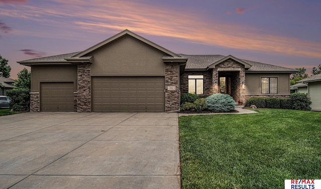948 S 198th St, Omaha, NE 68022 - prairie-style home featuring stone siding, a garage, concrete driveway, and stucco siding