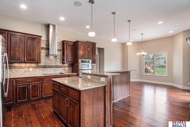 948 S 198th St, Omaha, NE 68022 - kitchen featuring wall chimney exhaust hood, a center island, dark wood-style floors, backsplash, and recessed lighting