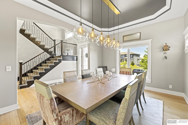 11412 S 122nd St, Papillion, NE 68046 - dining space with stairs, light wood-style flooring, baseboards, and a tray ceiling