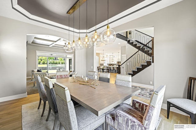 11412 S 122nd St, Papillion, NE 68046 - dining area with stairs, wood finished floors, baseboards, a tray ceiling, and a chandelier