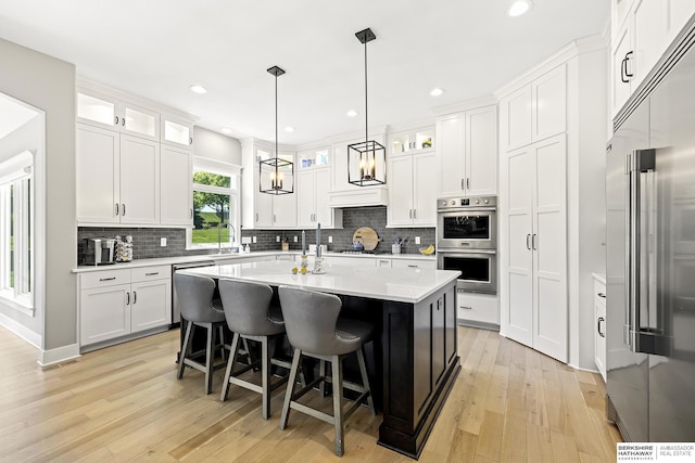 11412 S 122nd St, Papillion, NE 68046 - kitchen with appliances with stainless steel finishes, a sink, light countertops, light wood-style floors, and recessed lighting