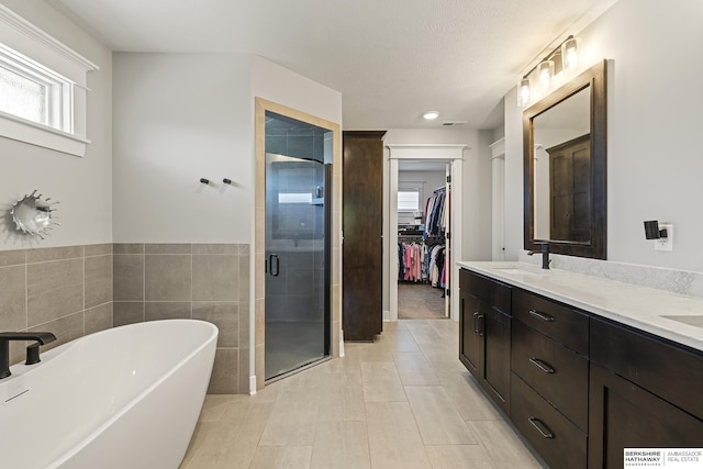 11412 S 122nd St, Papillion, NE 68046 - full bathroom featuring a shower stall, a soaking tub, a spacious closet, and double vanity