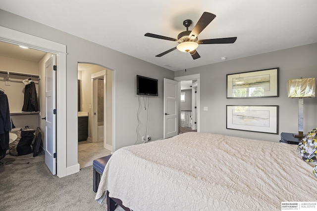 11412 S 122nd St, Papillion, NE 68046 - bedroom with a walk in closet, carpet, arched walkways, a closet, and connected bathroom
