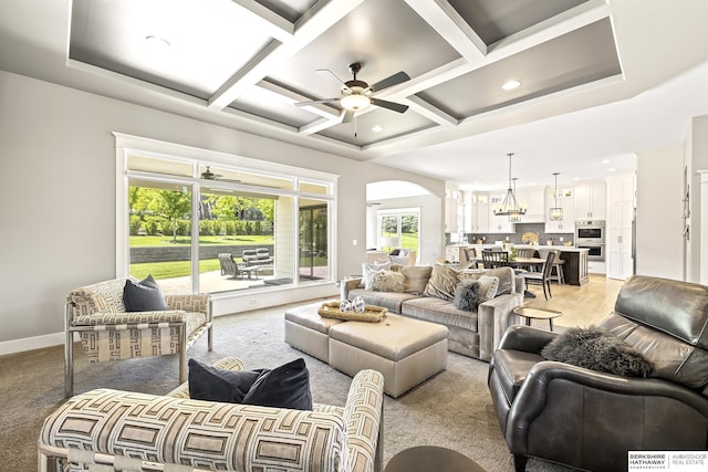 11412 S 122nd St, Papillion, NE 68046 - living room featuring ceiling fan, arched walkways, coffered ceiling, baseboards, and light carpet