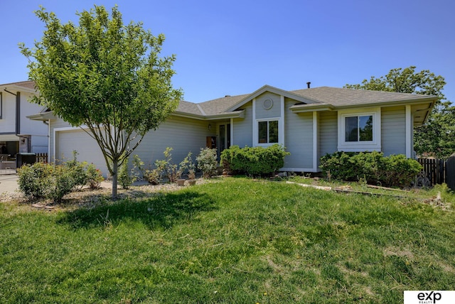 ranch-style house featuring a garage and a front lawn