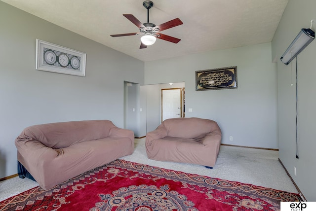 living area with carpet flooring, ceiling fan, and baseboards