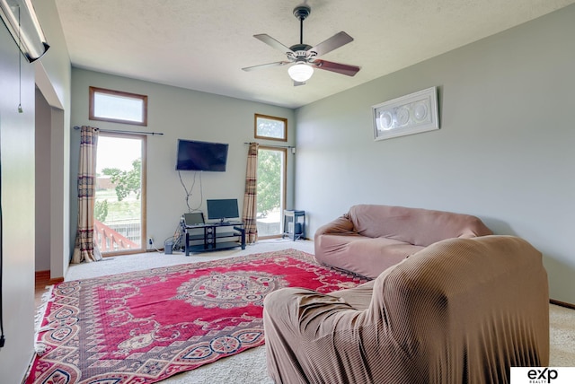living room with carpet flooring, plenty of natural light, and ceiling fan