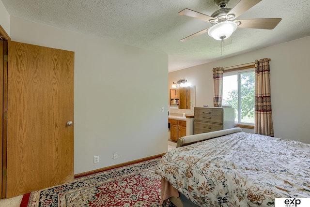 bedroom featuring a textured ceiling and baseboards