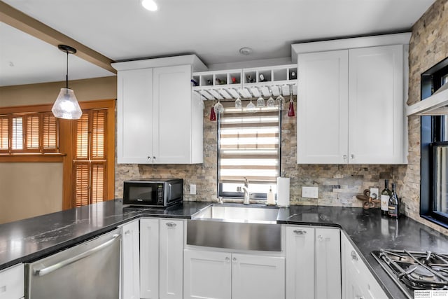 1530 S 52nd St, Omaha, NE 68106 - kitchen with black appliances, tasteful backsplash, dark countertops, and white cabinetry