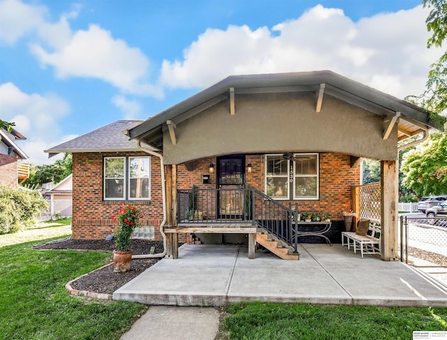 1530 S 52nd St, Omaha, NE 68106 - rear view of house with brick siding, ceiling fan, a patio, and stucco siding