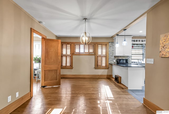 1530 S 52nd St, Omaha, NE 68106 - unfurnished dining area featuring wood finished floors and healthy amount of natural light