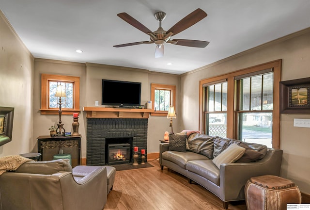1530 S 52nd St, Omaha, NE 68106 - living room featuring wood finished floors, crown molding, a ceiling fan, a brick fireplace, and recessed lighting