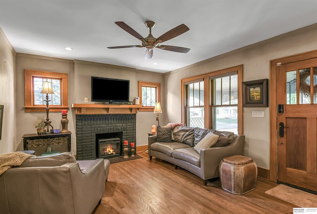1530 S 52nd St, Omaha, NE 68106 - living area with a ceiling fan, crown molding, wood finished floors, a fireplace, and recessed lighting