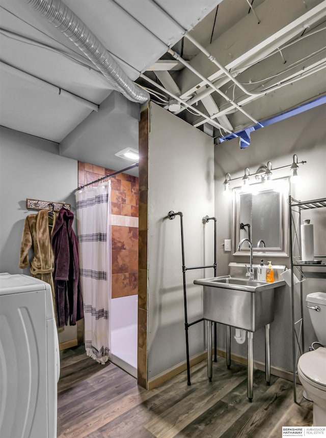1530 S 52nd St, Omaha, NE 68106 - bathroom with washer / dryer, curtained shower, and wood finished floors