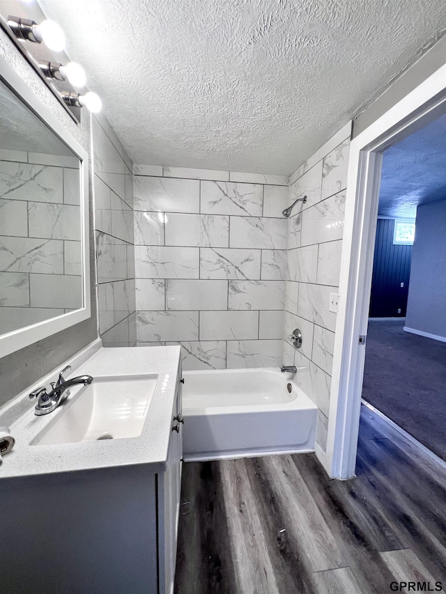 3941 X St, Omaha, NE 68107 - full bathroom with a textured ceiling, vanity, shower / bathtub combination, and wood finished floors