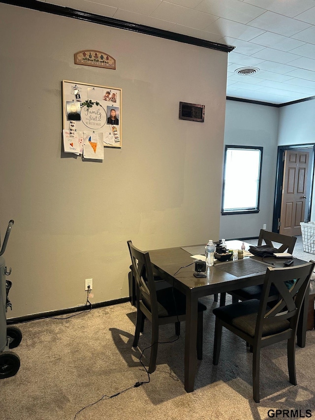 3941 X St, Omaha, NE 68107 - dining space featuring light colored carpet, crown molding, and baseboards