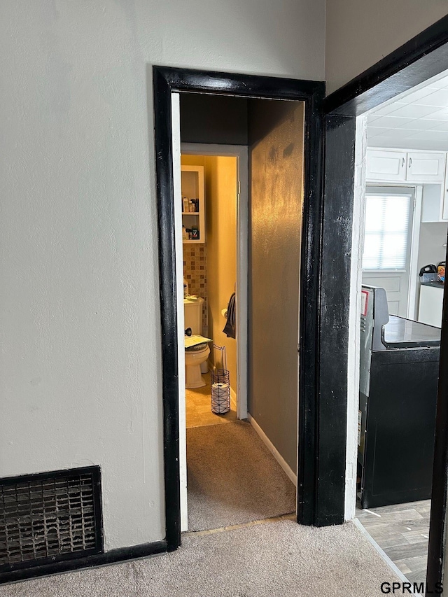 3941 X St, Omaha, NE 68107 - hall featuring washer / clothes dryer, carpet floors, and baseboards