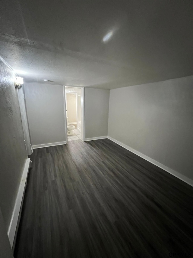 3941 X St, Omaha, NE 68107 - empty room with dark wood-type flooring and baseboards
