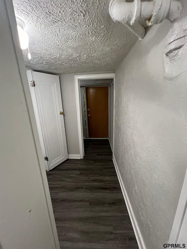 3941 X St, Omaha, NE 68107 - hallway with dark wood-style flooring, baseboards, a textured wall, and a textured ceiling