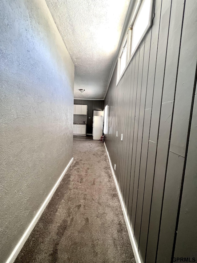 3941 X St, Omaha, NE 68107 - hallway featuring a textured wall, carpet flooring, a textured ceiling, and baseboards