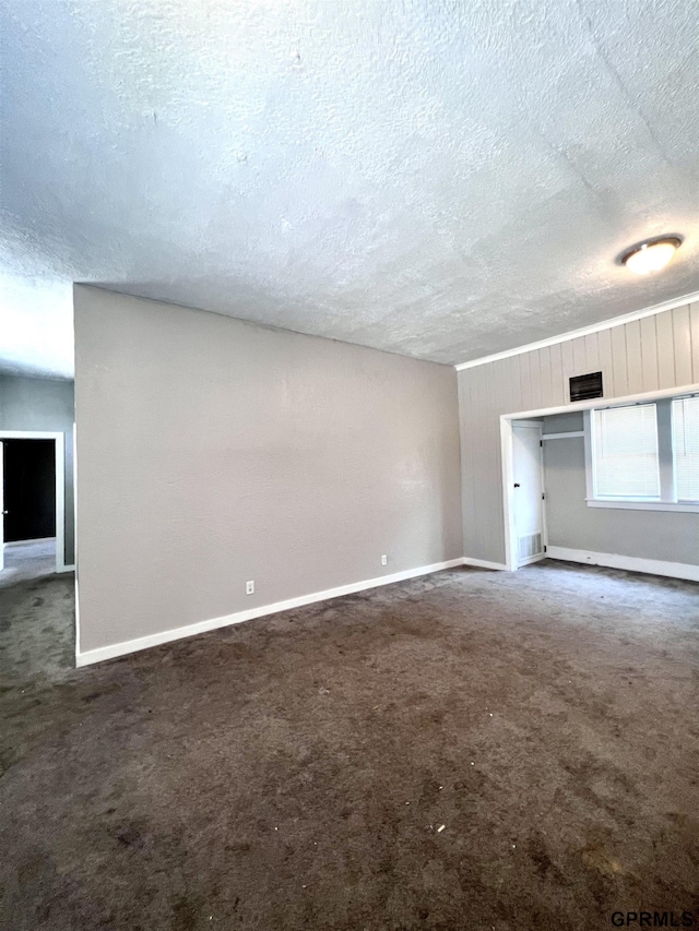 3941 X St, Omaha, NE 68107 - empty room with a textured ceiling, carpet, and baseboards