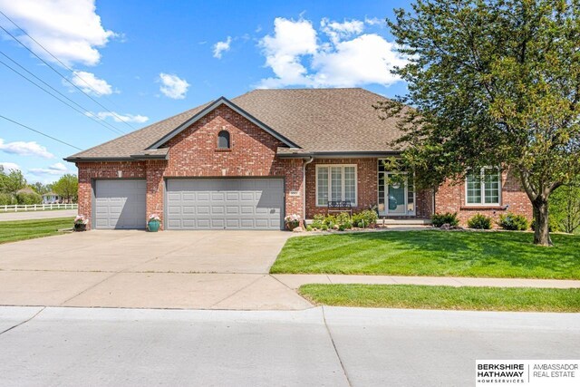 9901 S 176th St, Omaha, NE 68136 - view of front facade featuring a front lawn, driveway, an attached garage, brick siding, and a shingled roof