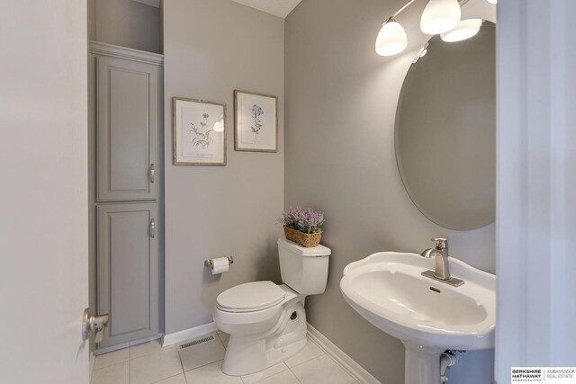 9901 S 176th St, Omaha, NE 68136 - half bath with a sink, baseboards, tile patterned flooring, and toilet