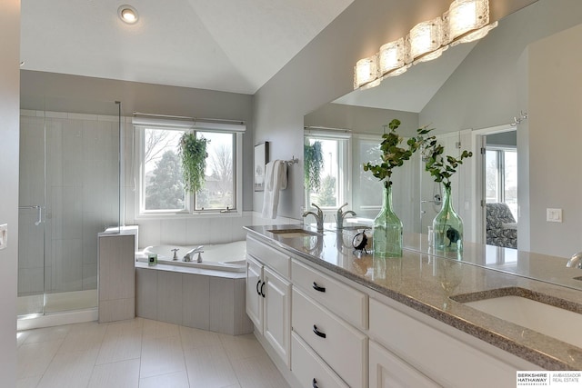 9901 S 176th St, Omaha, NE 68136 - bathroom with vaulted ceiling, double vanity, a garden tub, a shower stall, and tile patterned flooring