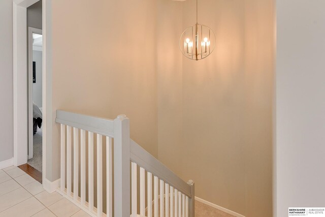 9901 S 176th St, Omaha, NE 68136 - stairs with a chandelier and tile patterned floors