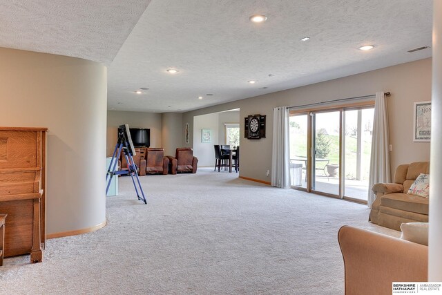 9901 S 176th St, Omaha, NE 68136 - living area featuring light colored carpet, a textured ceiling, baseboards, and recessed lighting