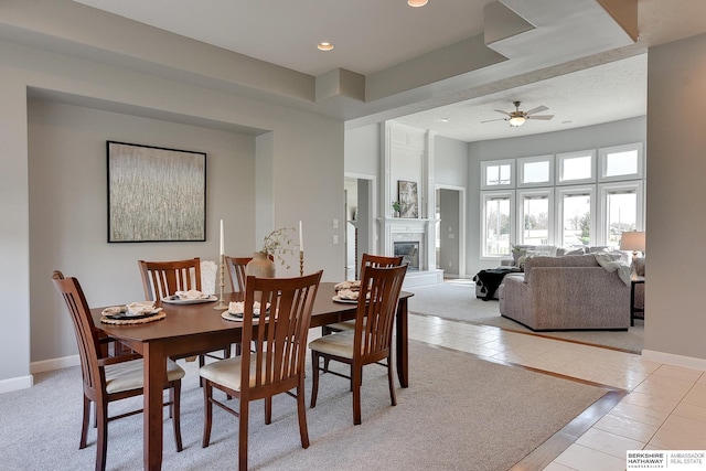 9901 S 176th St, Omaha, NE 68136 - dining room with light tile patterned flooring, baseboards, a glass covered fireplace, ceiling fan, and recessed lighting