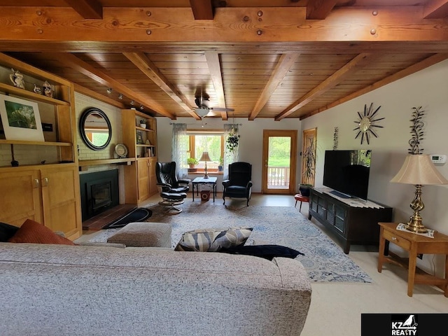 living area featuring wooden ceiling, beamed ceiling, a glass covered fireplace, and built in features