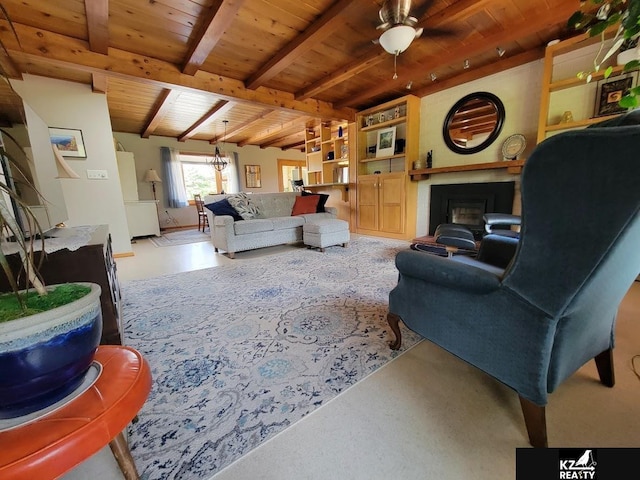 living area with wooden ceiling, a fireplace, ceiling fan, and beamed ceiling
