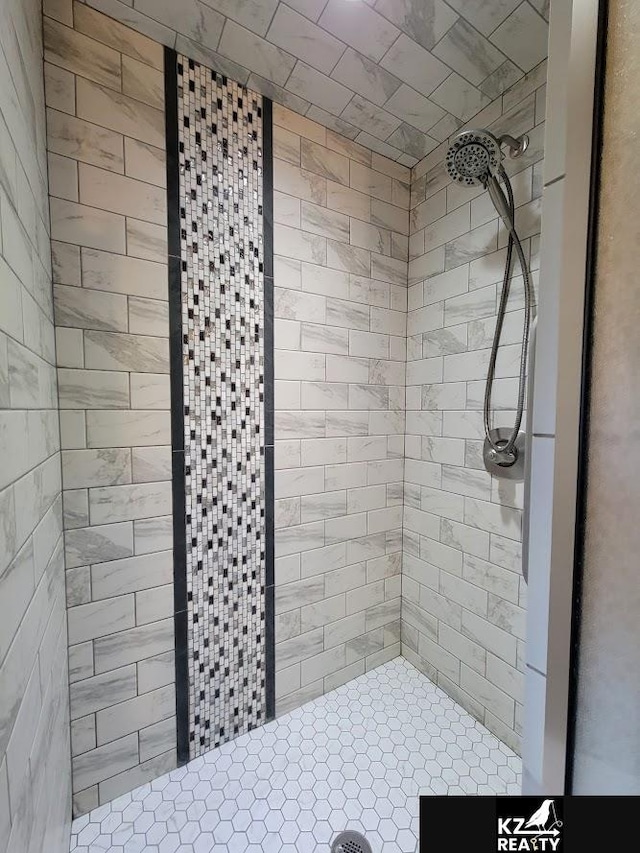 full bath featuring a tile shower