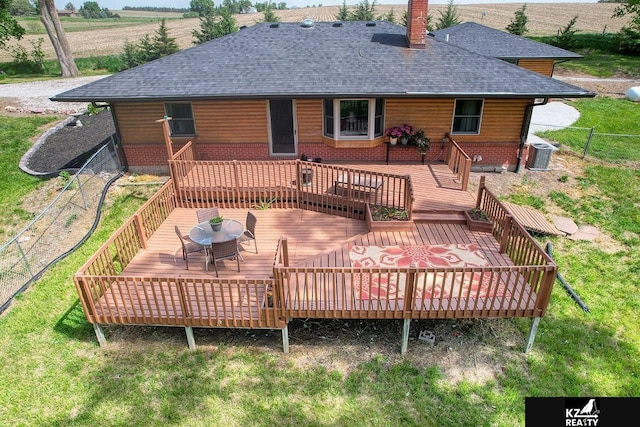 back of property featuring a chimney, roof with shingles, a deck, fence, and central AC unit