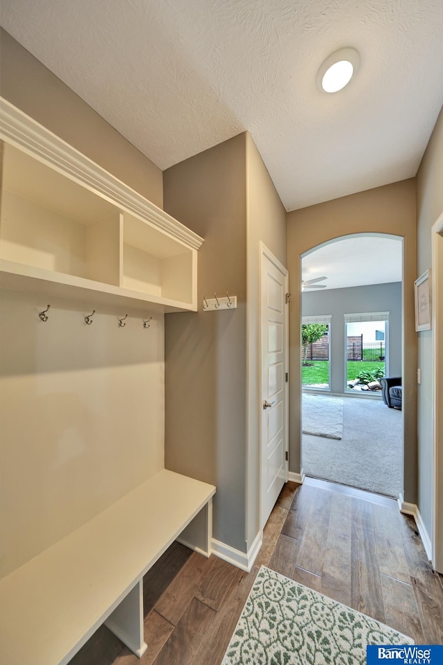 7308 Andy Dr, Lincoln, NE 68516 - mudroom featuring arched walkways, wood finished floors, and baseboards