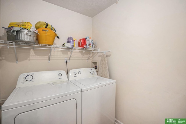 washroom featuring washing machine and clothes dryer and baseboards