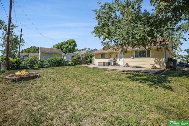 view of yard with an outdoor fire pit and a patio