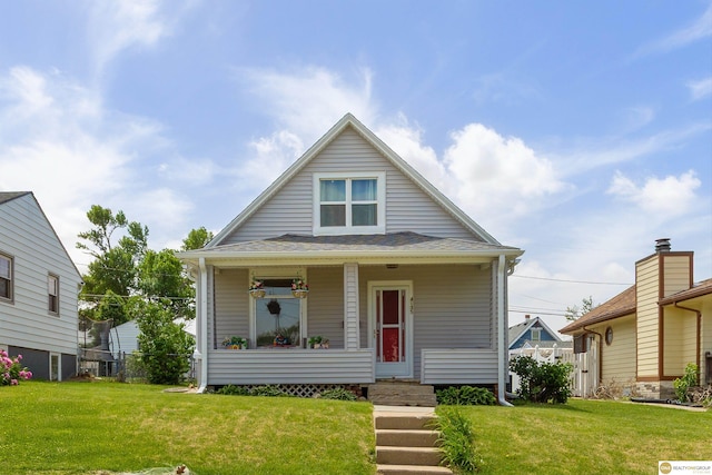 bungalow-style house featuring a porch and a front lawn