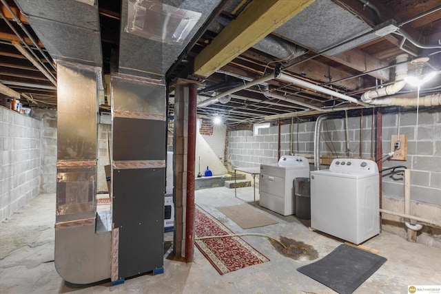 unfinished basement with washing machine and clothes dryer and heating unit