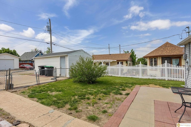 view of yard featuring a garage and a gate