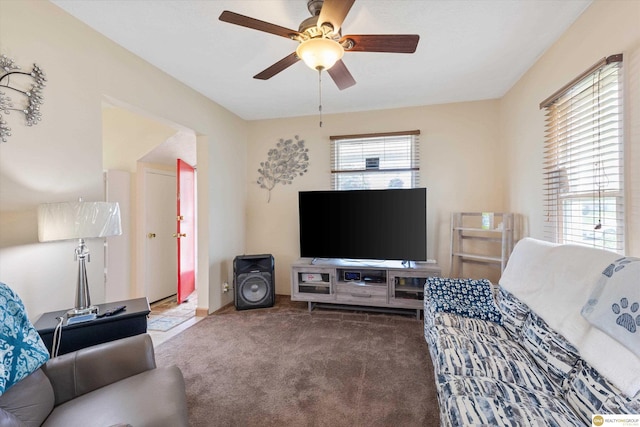 carpeted living area featuring a ceiling fan