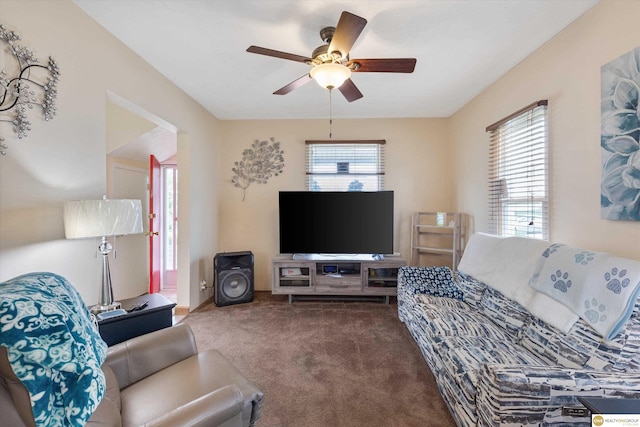 living area featuring carpet floors and a ceiling fan
